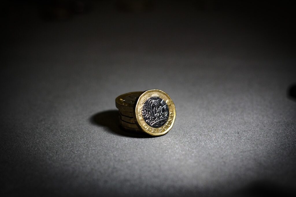 Pound coins on a dark neutral surface